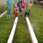 Race ducks with squirt guns in some gutters